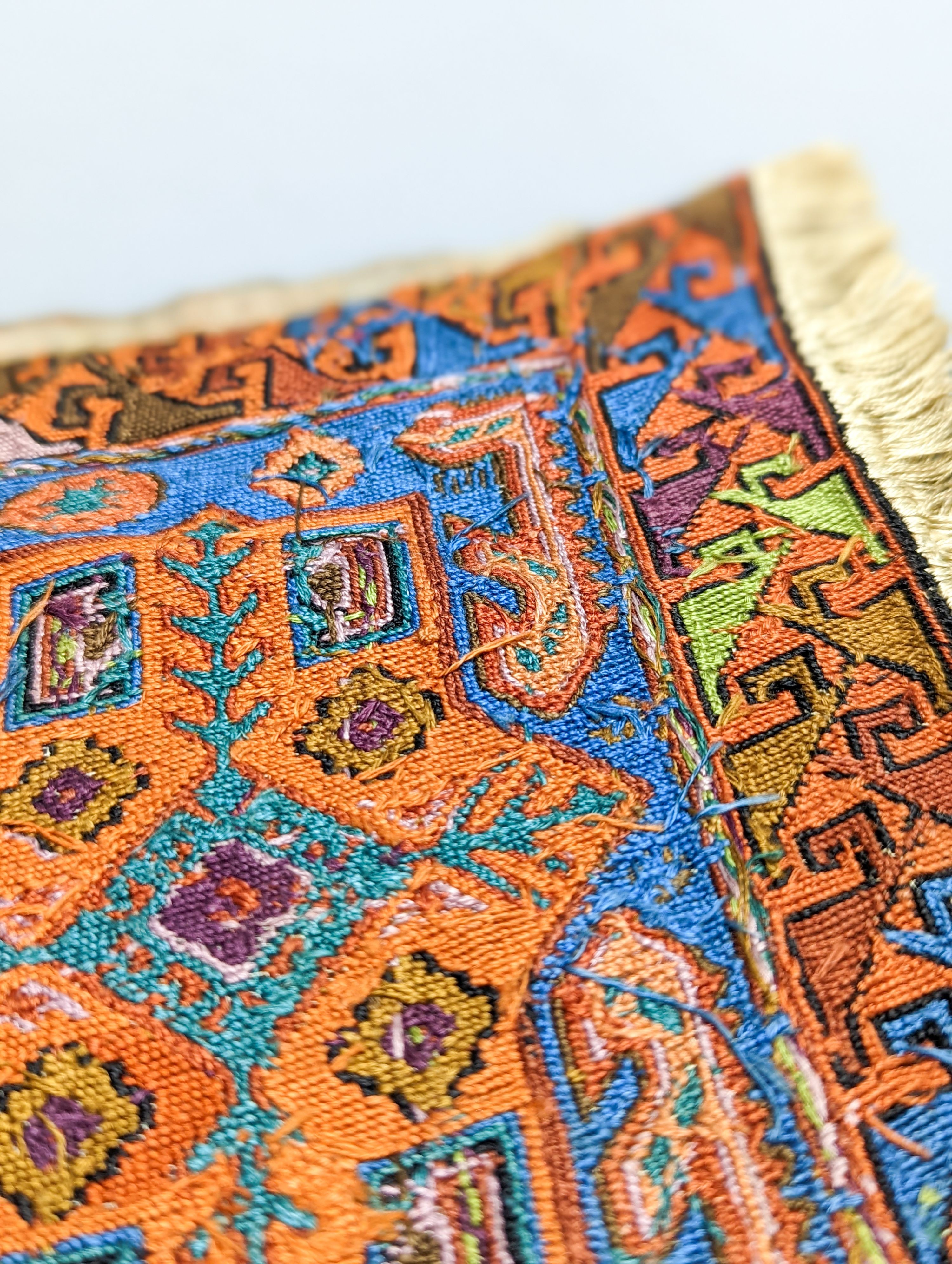 A Caucasian style petit point miniature rug 33x20cm